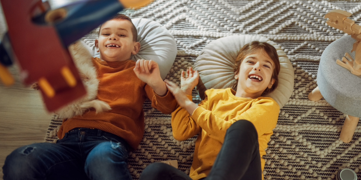 Children lying down on a rug